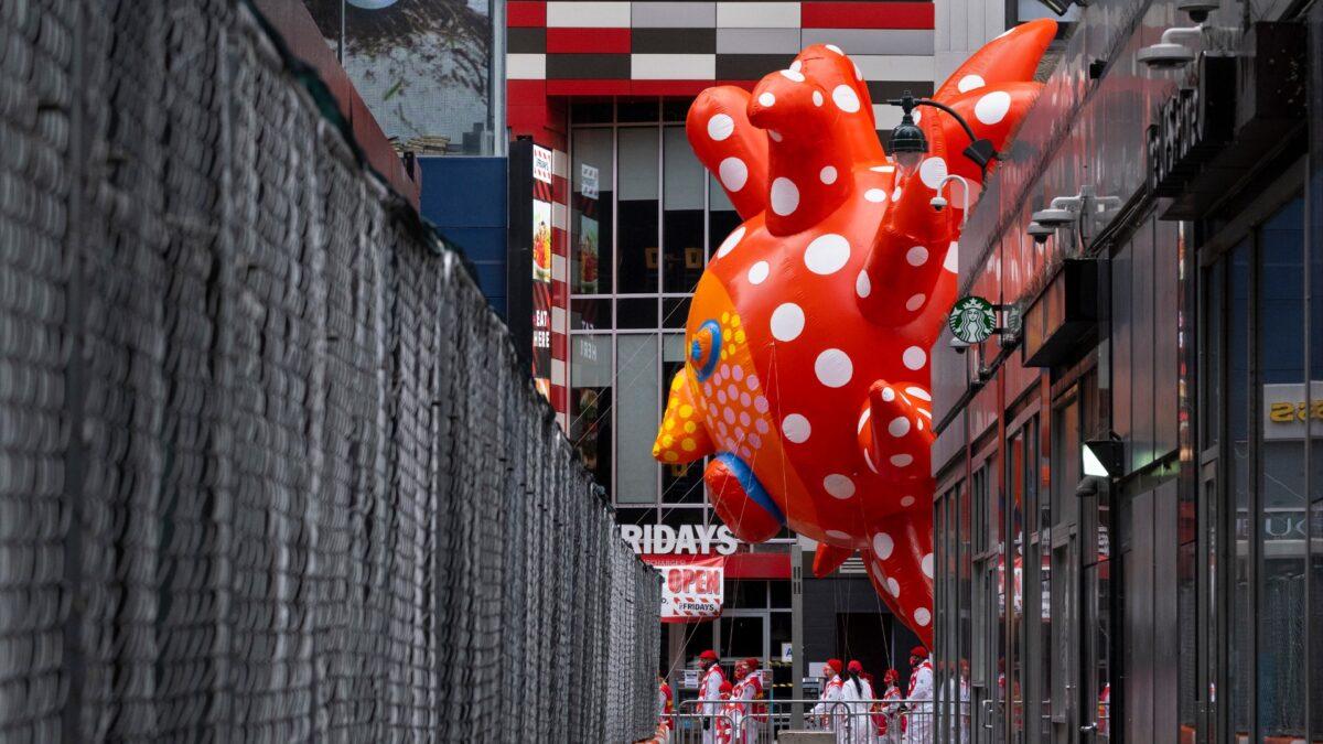 A large balloon appears through a narrow passageway from a street adjacent to the parade route during the modified Macy's Thanksgiving Day Parade in New York City, on Nov. 26, 2020. (Craig Ruttle/AP Photo)