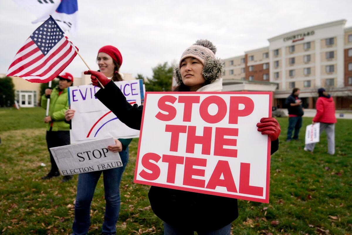 Supporters of President Donald Trump gather outside of the Wyndham Hotel before a Pennsylvania State Senate Majority Policy Committee hearing, in Gettysburg, Pa., on Nov. 25, 2020. (Julio Cortez/AP Photo)