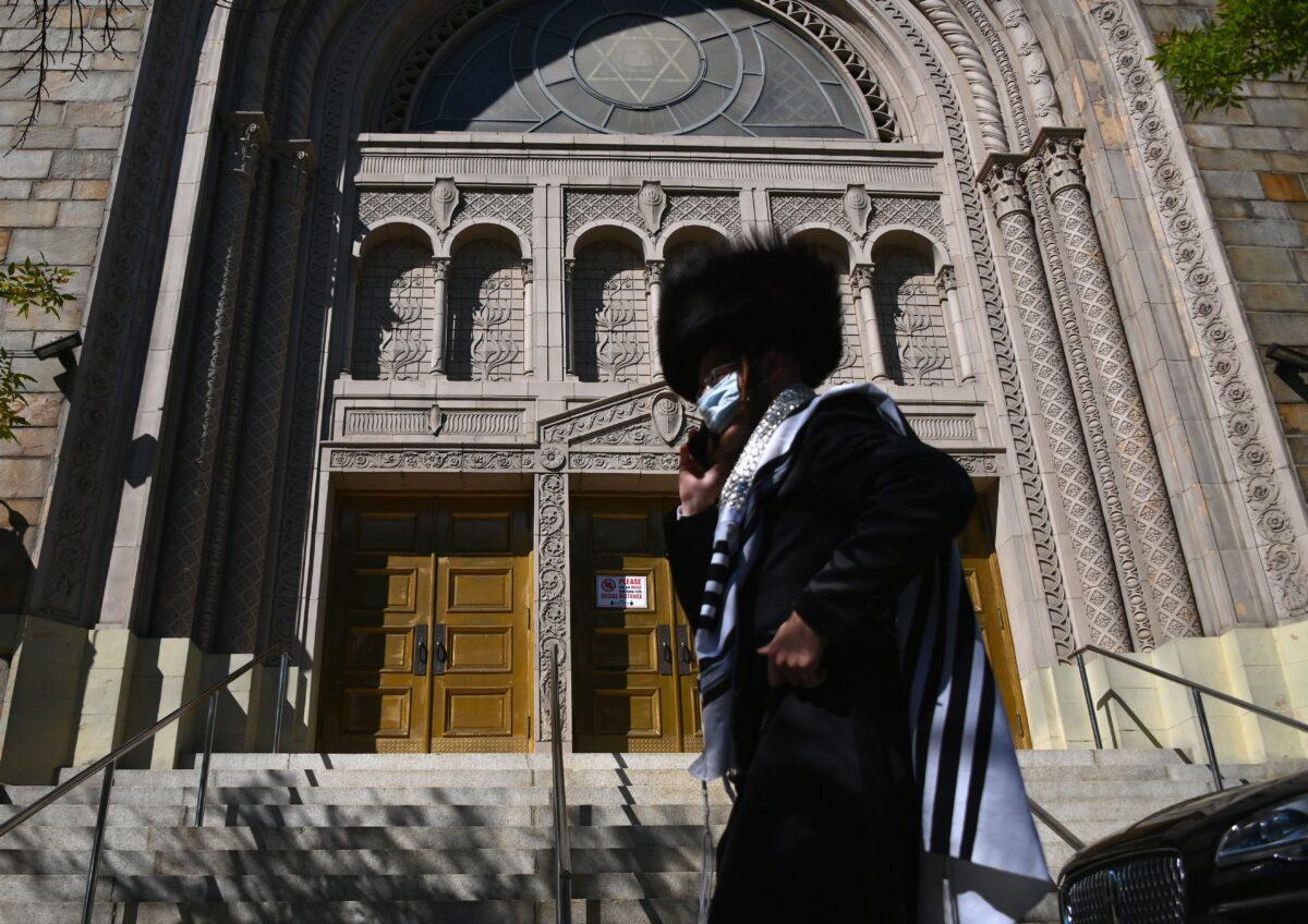 A Hasidic Jew walks past a closed synagogue in the Borough Park section of Brooklyn, New York, on Oct. 9, 2020. (Angela Weiss/AFP via Getty Images)