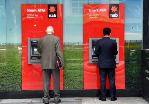 Two people use National Australia Bank (NAB) ATMs in Melbourne on May 2, 2019(William West/AFP via Getty Images)