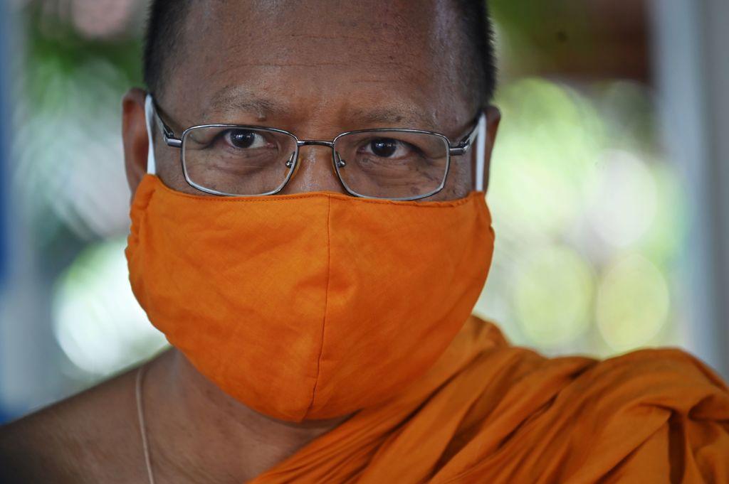 Abbot of Wat Chak Daeng Buddhist temple wears a face mask made from recycled plastic bottles. (LILLIAN SUWANRUMPHA/AFP via Getty Images)