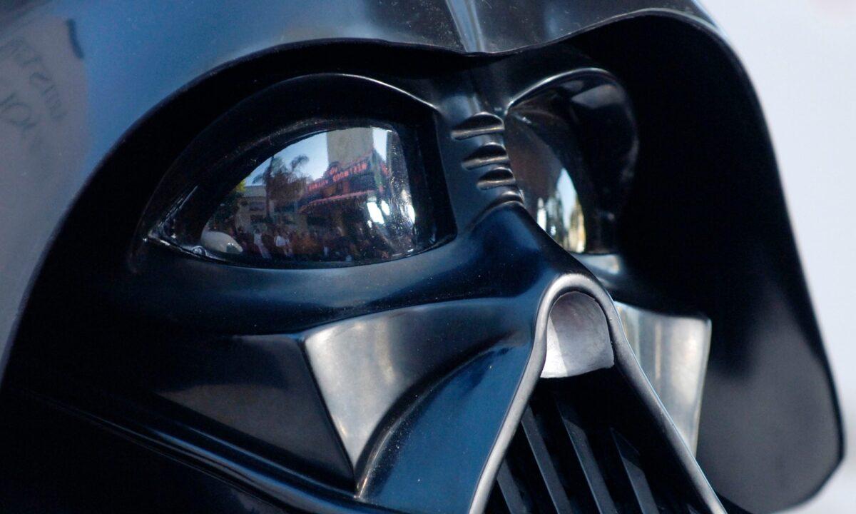 The Los Angeles premiere of the movie "Star Wars: Revenge of the Sith", is reflected in the mask eyeglasses of iconic baddie character Darth Vader on May 12, 2005. (Chris Pizzello/AP Photo)
