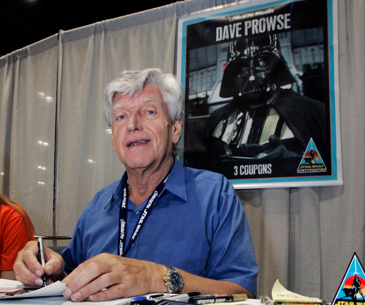 Actor David Prowse, who was the man in the black Darth Vader suit in the first Star Wars film, signs autographs on May 26, 2007, at Star Wars Celebration IV in Los Angeles, marking the 30th anniversary of the release of the first film in the Star Wars saga. (Reed Saxon/AP Photo)