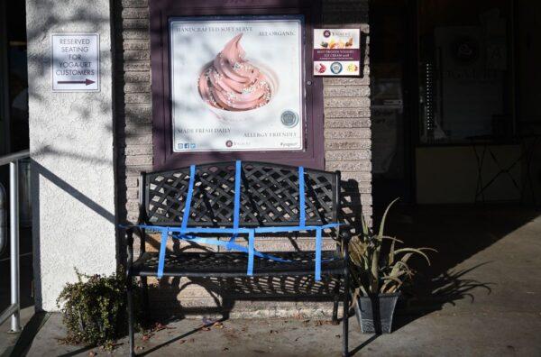 A bench is covered in tape to prevent use outside a frozen dessert shop in Glendale, Los Angeles County, on Nov. 29, 2020. (Robyn Beck/AFP via Getty Images)