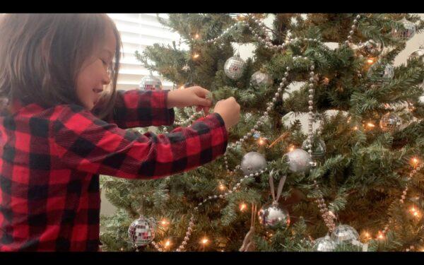 Elizabeth Chan's daughter decorates a Christmas tree in the music video "Celebrate Me Home." (Courtesy of Elizabeth Chan)