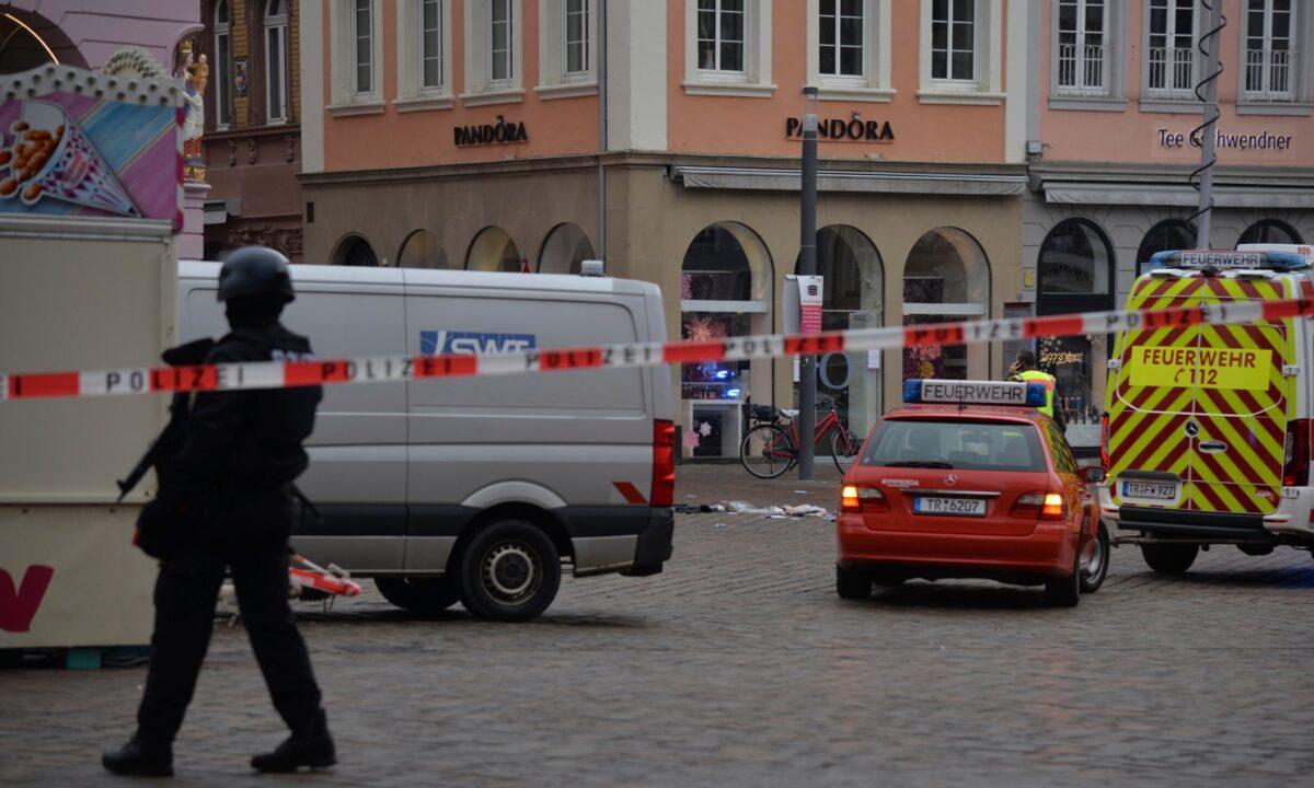 German police block a square after a driver drove into a pedestrian zone killing two and seriously injuring 15 in Trier, German, on Dec. 1, 2020. (Harald Tittel/dpa via AP)