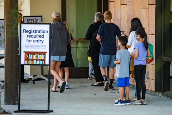 People wait in line to enter the newly opened public library in Yorba Linda, Calif., on Nov. 30, 2020. (John Fredricks/The Epoch Times)