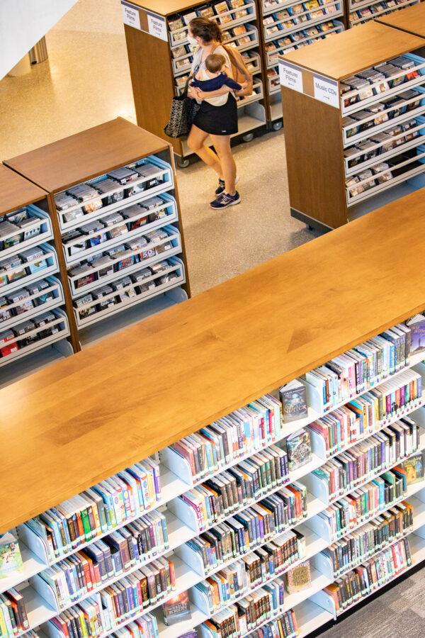 A woman walks through the stacks of the new public library in Yorba Linda, Calif., on Nov. 30, 2020. (John Fredricks/The Epoch Times)