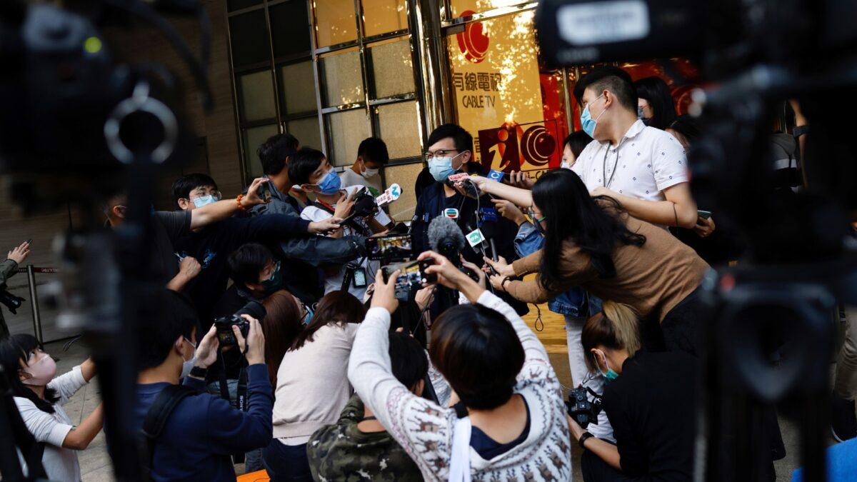 i-Cable TV news journalist talks to the media after being laid off in Hong Kong on Dec.1, 2020. (Tyrone Siu/Reuters)