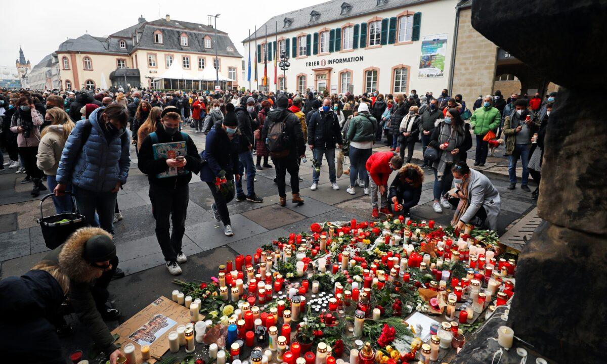 People pay their respects near the site where a car crashed into pedestrians in Trier, Germany, on Dec. 2, 2020. (Kai Pfaffenbach/Reuters)