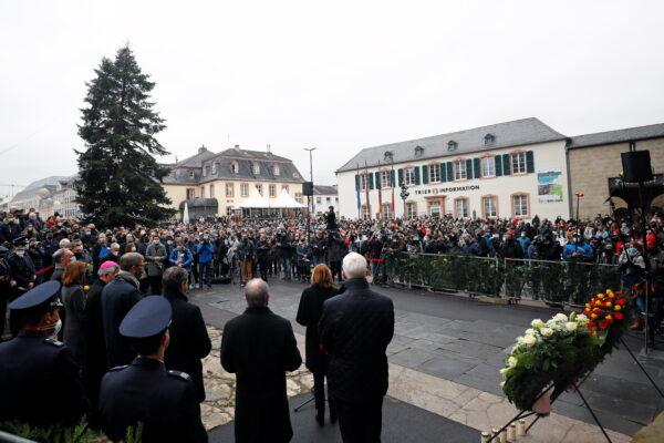 People gather to pay their respects near the site where a car crashed into pedestrians in Trier, Germany, on Dec. 2, 2020. (Kai Pfaffenbach/Reuters)