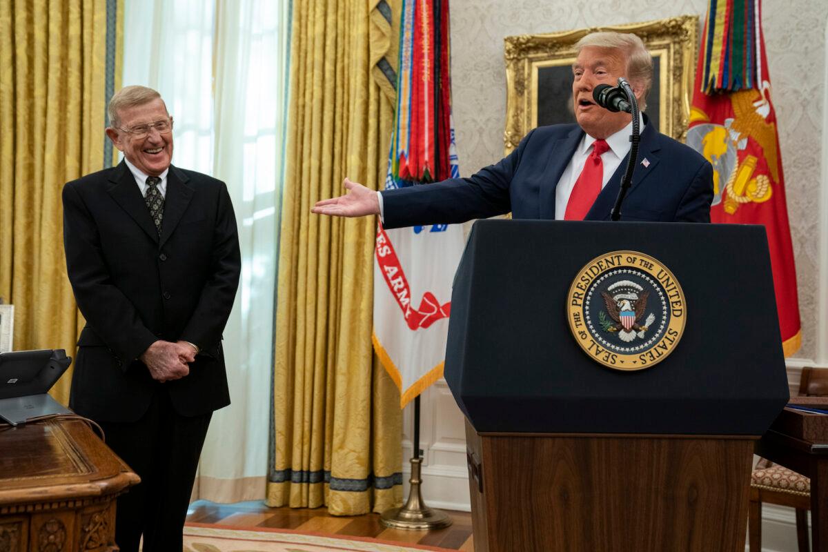 President Donald Trump speaks during a ceremony to present the Presidential Medal of Freedom to former football coach Lou Holtz, in the Oval Office of the White House, in Washington, on Dec. 3, 2020. (AP Photo/Evan Vucci)