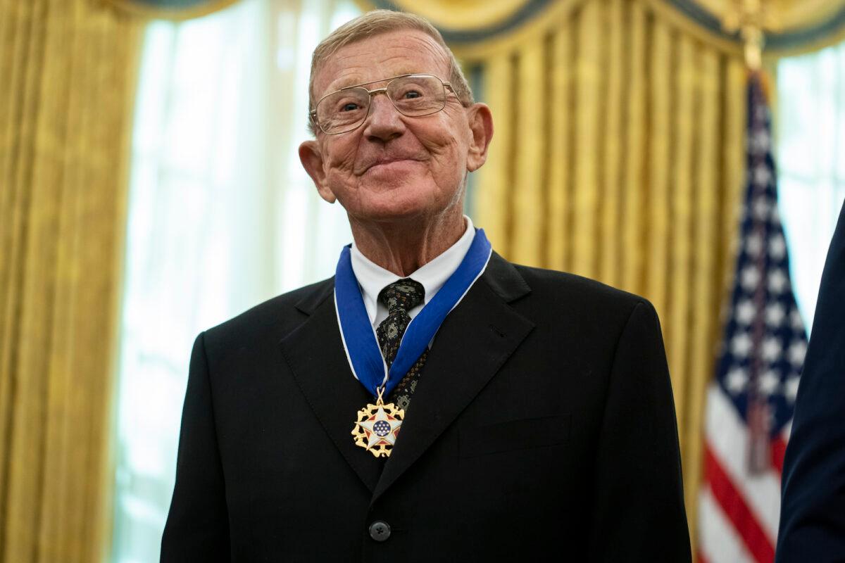 Former football coach Lou Holtz smiles after receiving the Presidential Medal of Freedom from President Donald Trump, in the Oval Office of the White House, in Washington, on Dec. 3, 2020. (AP Photo/Evan Vucci)
