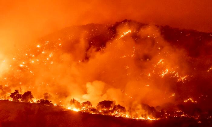 Californians Flee as Strong Winds Push Fire Through Canyons