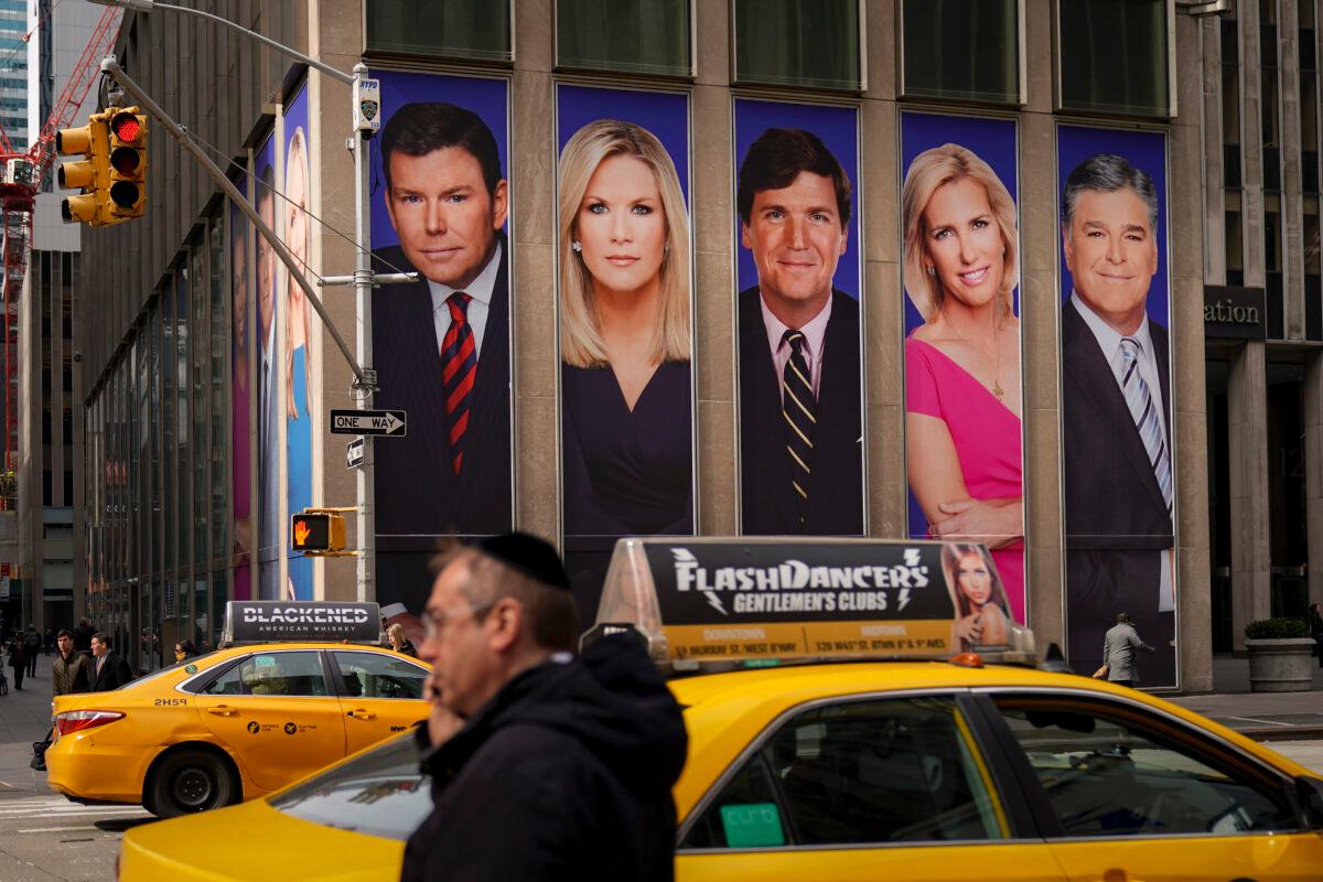 An advertisement features Fox News personalities, including Tucker Carlson and Sean Hannity, in New York City on March 13, 2019. (Drew Angerer/Getty Images)
