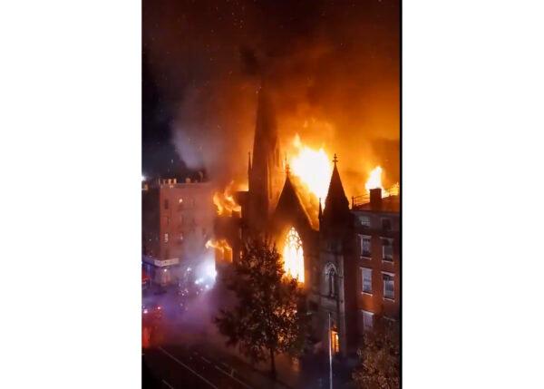Firefighters work to extinguish a fire that erupted from a building next to Middle Collegiate Church in New York, on Saturday, Dec. 5, 2020. (Duke Todd via AP)