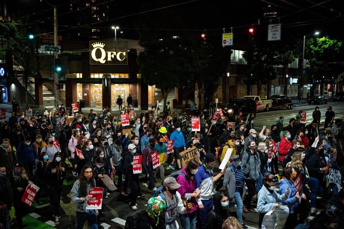  Demonstrators march to the Seattle Police Department's East Precinct after marching inside Seattle City Hall, led by Seattle Councilwoman Kshama Sawant, in Seattle on June 9, 2020. (David Ryder/Getty Images)