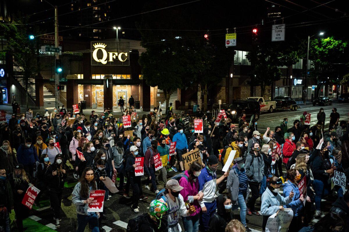 Demonstrators march to the Seattle Police Department's East Precinct after marching inside Seattle City Hall, led by Seattle Councilwoman Kshama Sawant, in Seattle on June 9, 2020. (David Ryder/Getty Images)