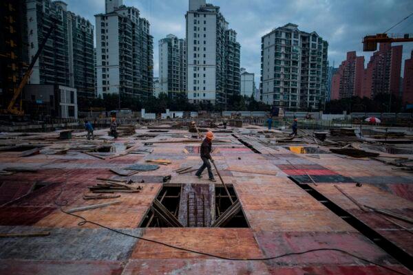 A man works at a construction site of a residential skyscraper in Shanghai on Nov. 29, 2016. (Johannes Eisele/AFP via Getty Images)