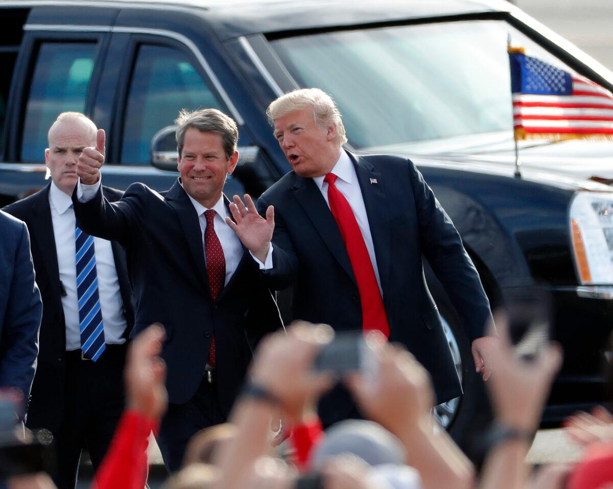 Then-Georgia Republican gubernatorial candidate Brian Kemp (L) walks with President Donald Trump as Trump arrives for a rally in Macon, Ga., on Nov. 4, 2018. (John Bazemore/AP Photo)