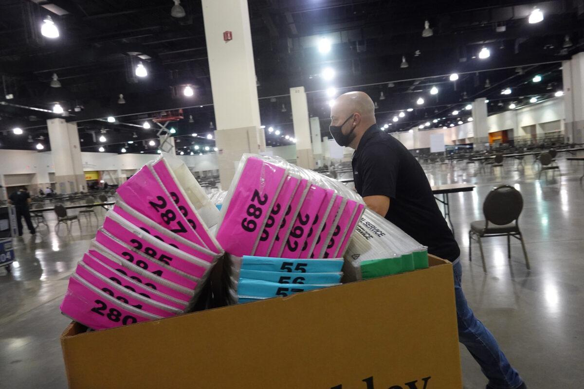 A worker brings supplies into the Wisconsin Center to aid in the partial recount of the presidential election, in Milwaukee, Wis., on Nov. 19, 2020. (Scott Olson/Getty Images)