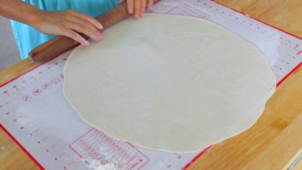 Roll out the dough into a thin, round sheet. (CiCi Li)
