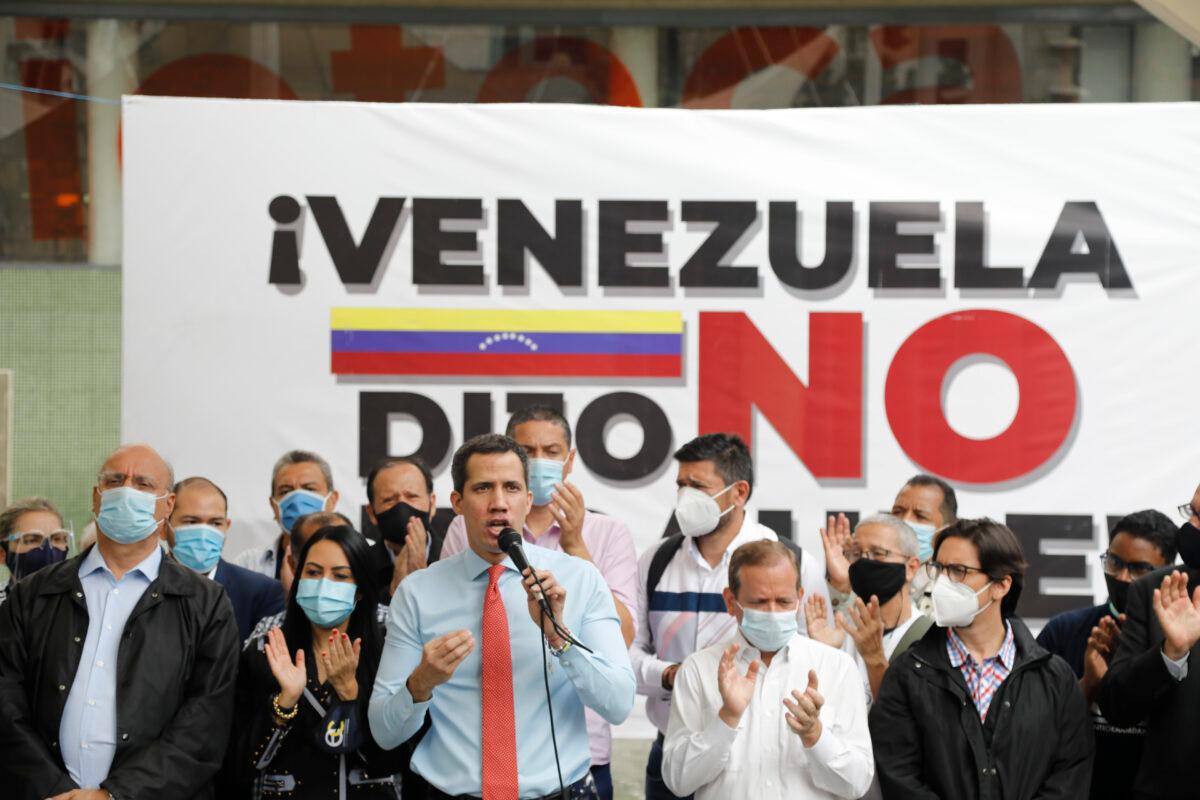 Flanked by party members, Venezuelan opposition leader Juan Guaido speaks during a press conference, a day after parliamentary elections, in Caracas, Venezuela, on, Dec. 7, 2020. (Ariana Cubillos/The Associated Press)