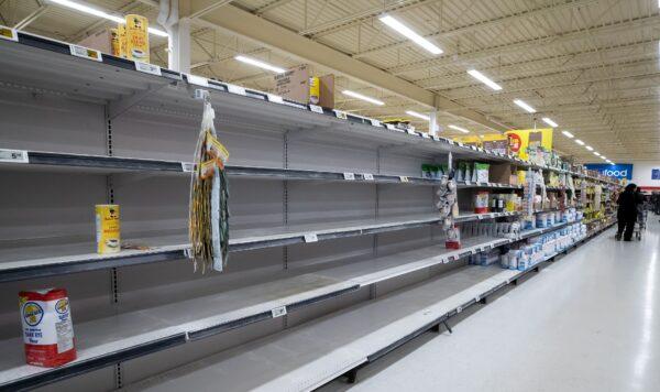 Empty shelves are seen at a Superstore grocery in Richmond, B.C., as a result of panic-buying amid concerns about the spread of COVID-19, on March 17, 2020. (Darryl Dyck/The Canadian Press)