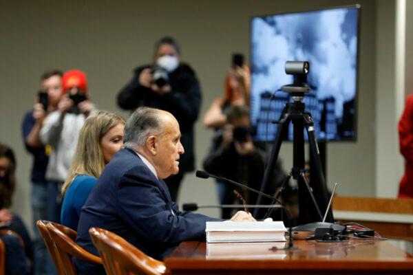 Jenna Ellis (L) and Rudy Giuliani (R) appear before the Michigan House Oversight Committee in Lansing, Mich., on Dec. 2, 2020. (Jeff Kowalsky/AFP via Getty Images)