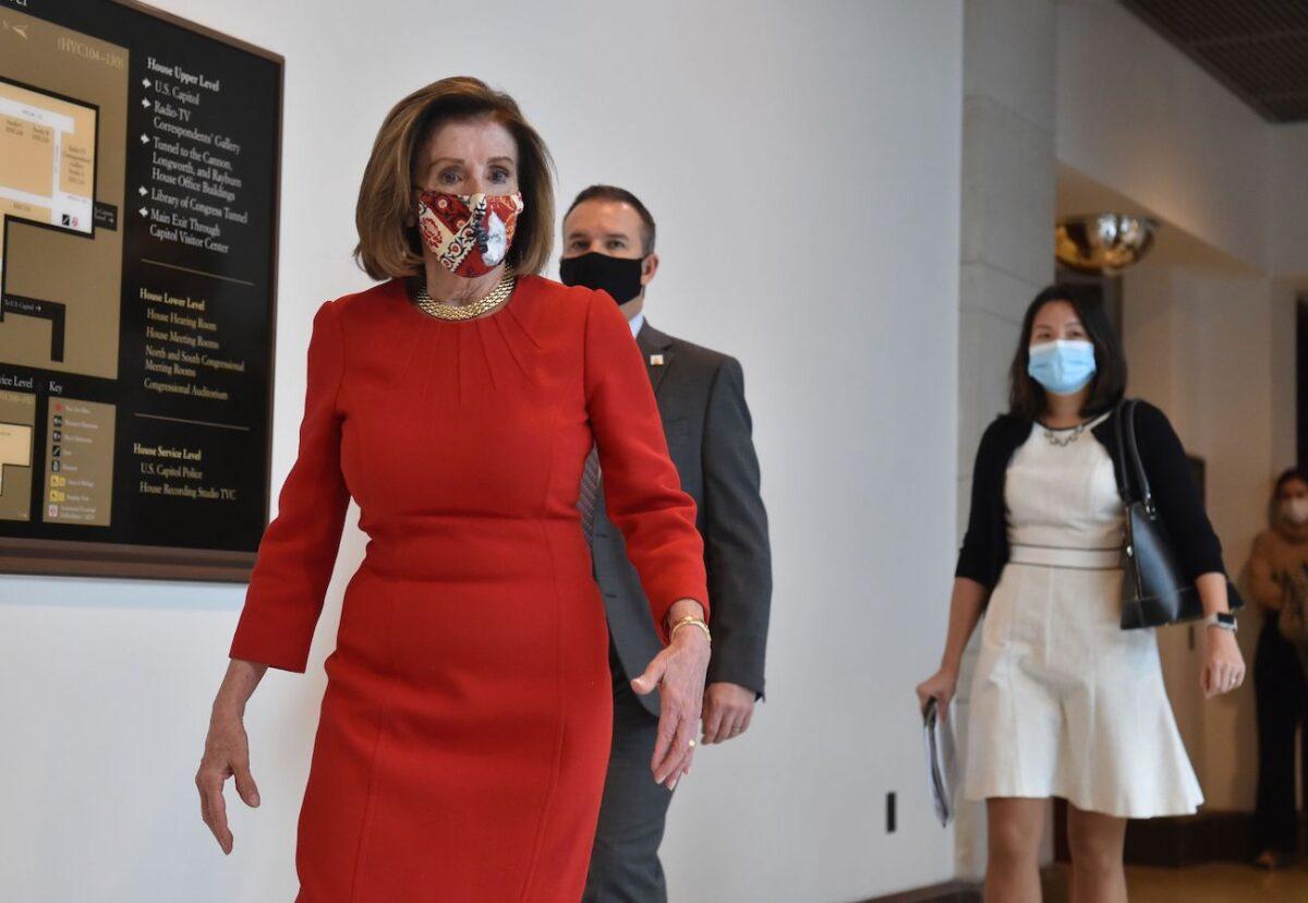 House Speaker Nancy Pelosi (D-Calif.) leaves after speaking at a press briefing at Capitol Hill, in Washington, on Dec. 4, 2020. (Nicholas Kamm/AFP via Getty Images)