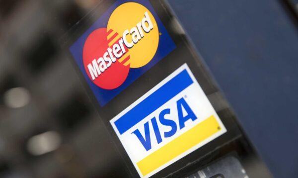 This Nov. 29, 2018, file photo shows credit card logos posted on a store's door in Philadelphia. (Matt Rourke/AP Photo)