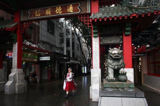 A woman walks through the Chinatown district arch on March 04, 2020, in Sydney, Australia. (Lisa Maree Williams/Getty Images)