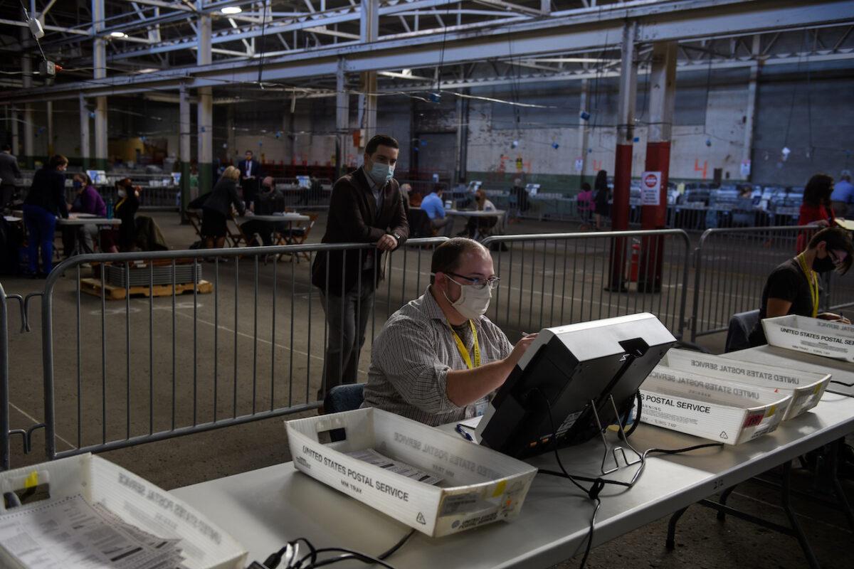 A poll watcher monitors the counting of ballots at the Allegheny County elections warehouse in Pittsburgh, Pennsylvania, on Nov. 6, 2020. (Jeff Swensen/Getty Images)