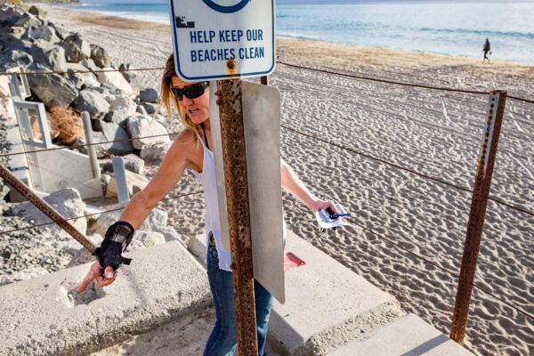 Deborah Sheldrake-Stetson stands near the spot where a community Christmas tree she erects annually stood before it recently disappeared at Calafia Beach in San Clemente, Calif., on Dec. 8, 2020. (John Fredricks/The Epoch Times)