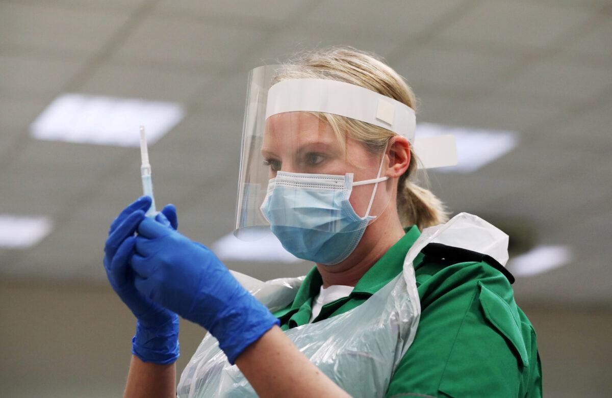 A St. John's Ambulance volunteer holds a syringe during a COVID-19 vaccinator training course in Derby, UK, on Nov. 28, 2020. (Lee Smith/File Photo/Reuters)