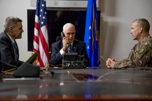 Vice President Mike Pence, accompanied by U.S. Ambassador to Iraq Matthew Tueller (L) and Lt. Gen. Pat White (R) takes a phone call with Iraqi Prime Minister Adil Abdul-Mahdi at Al Asad Air Base, Iraq, on Nov. 23, 2019. (Andrew Harnik, File/AP Photo)