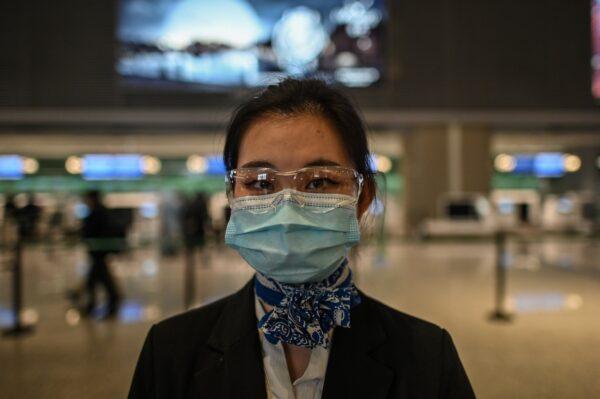 An airline worker is at Shanghai Hongqiao International Airport in Shanghai, on Nov. 27, 2020. (HECTOR RETAMAL/AFP via Getty Images)
