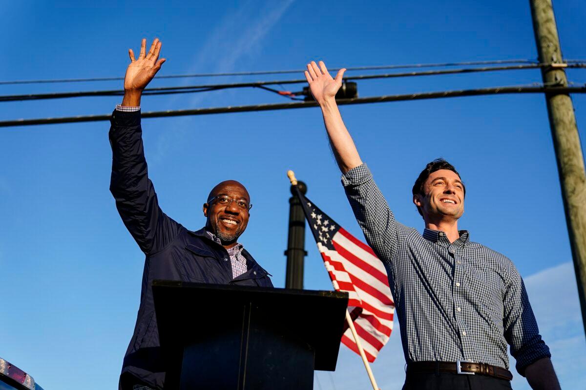 Georgia Democrat candidates for U.S. Senate Raphael Warnock, left, and Jon Ossoff, right, gesture toward a crowd during a campaign rally in Marietta, Ga., on Nov. 15, 2020. (Brynn Anderson/AP Photo)