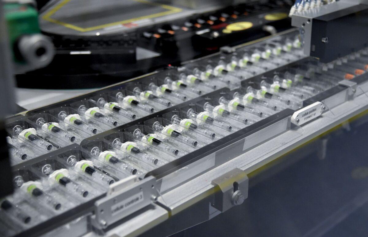 Vials on a production line at the factory of GlaxoSmithKline in Saint-Amand-les-Eaux, northern France, on Dec. 3, 2020. (Francois Lo Presti/AFP via Getty Images)