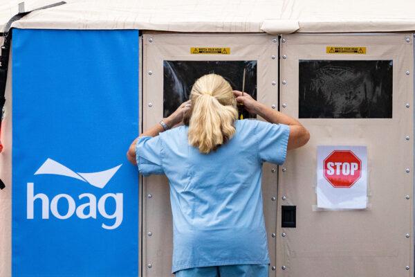 A nurse looks into an emergency triage tent set up outside Hoag Memorial Hospital in Irvine, Calif., on Dec. 11, 2020. (John Fredricks/The Epoch Times)