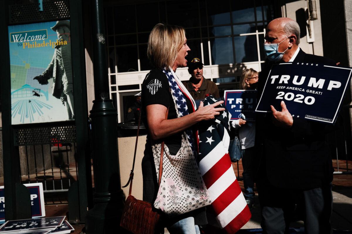 Rep. Louie Gohmert (R-Texas) holds a Trump 2020 sign outside of the Pennsylvania Convention Center as he speaks to a protester, in Philadelphia, on Nov. 6, 2020. (Spencer Platt/Getty Images)