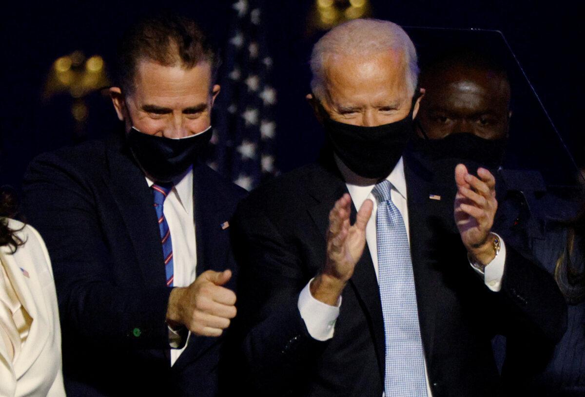 Hunter Biden, left and Democratic presidential nominee Joe Biden cheer on stage during a rally in Wilmington, Del., on Nov. 7, 2020. (Jim Bourg/Reuters)