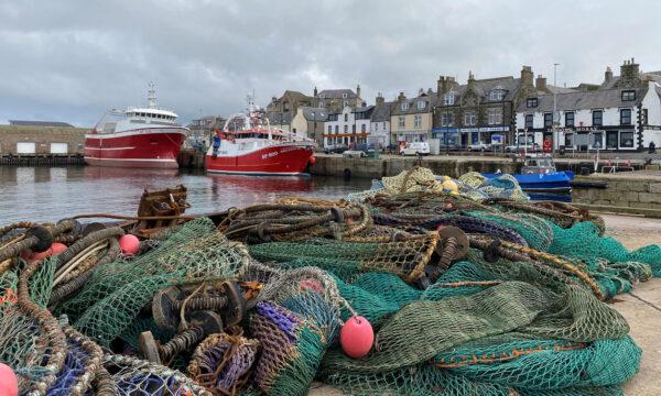 View of fishing boats and a net in the coastal town of Macduff, Aberdeenshire, Scotland, on Oct. 18, 2020. (Alexander Smith/Reuters)