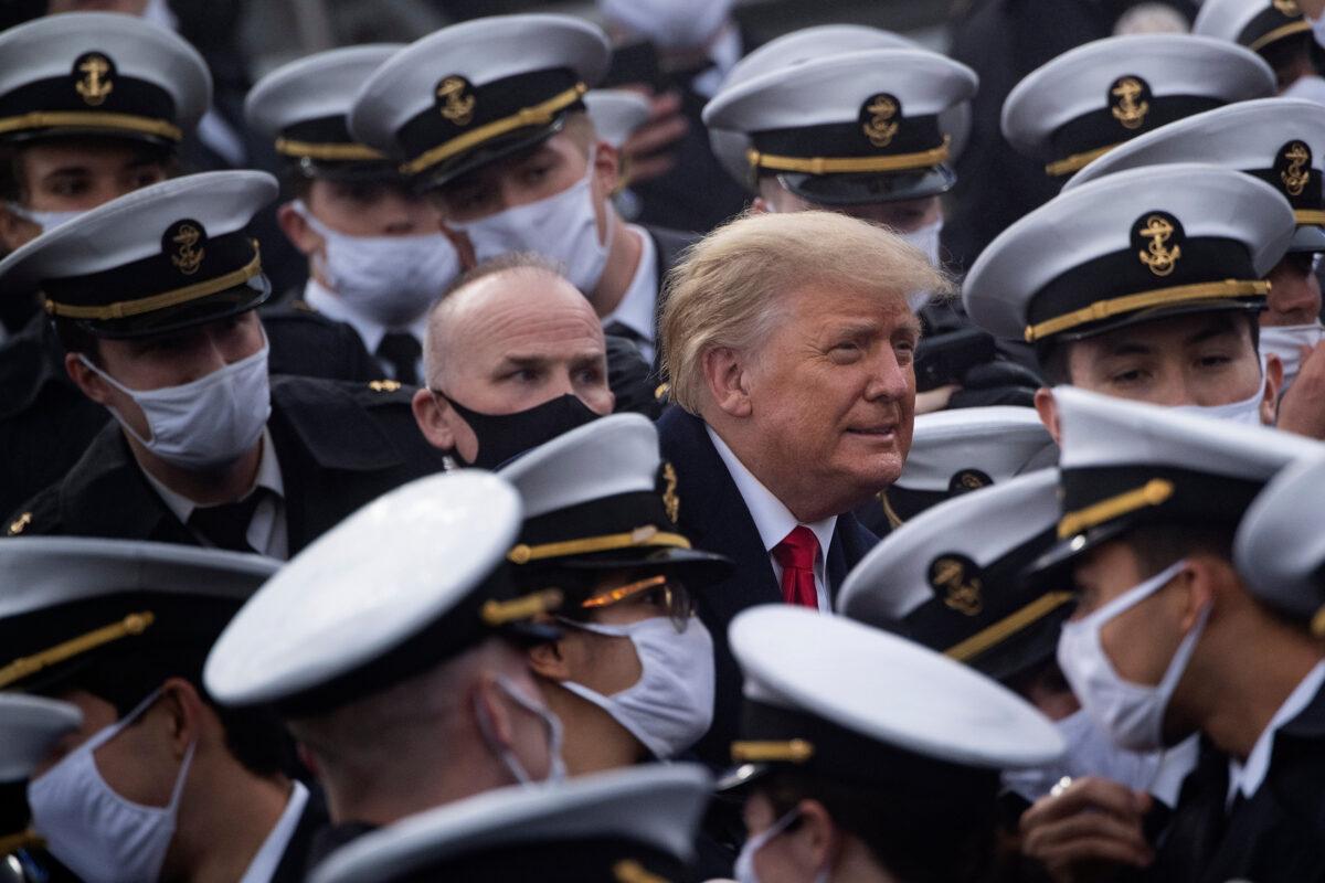 President Donald Trump poses with Navy Academy cadets during Army-Navy football game at Michie Stadium in West Point, N.Y., on Dec. 12, 2020. (Brendan Smialowski/AFP via Getty Images)