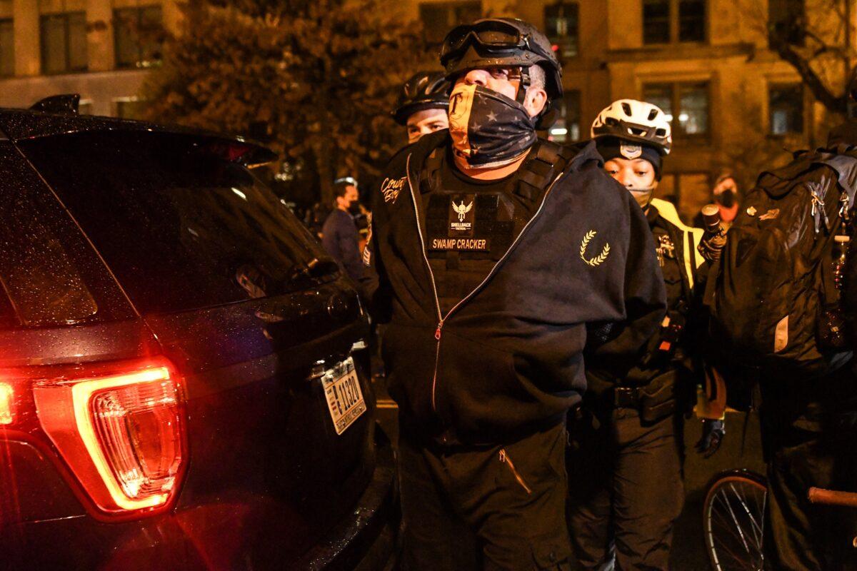 A member of the Proud Boys is detained by police during a protest in Washington on Dec. 12, 2020. (Stephanie Keith/Getty Images)