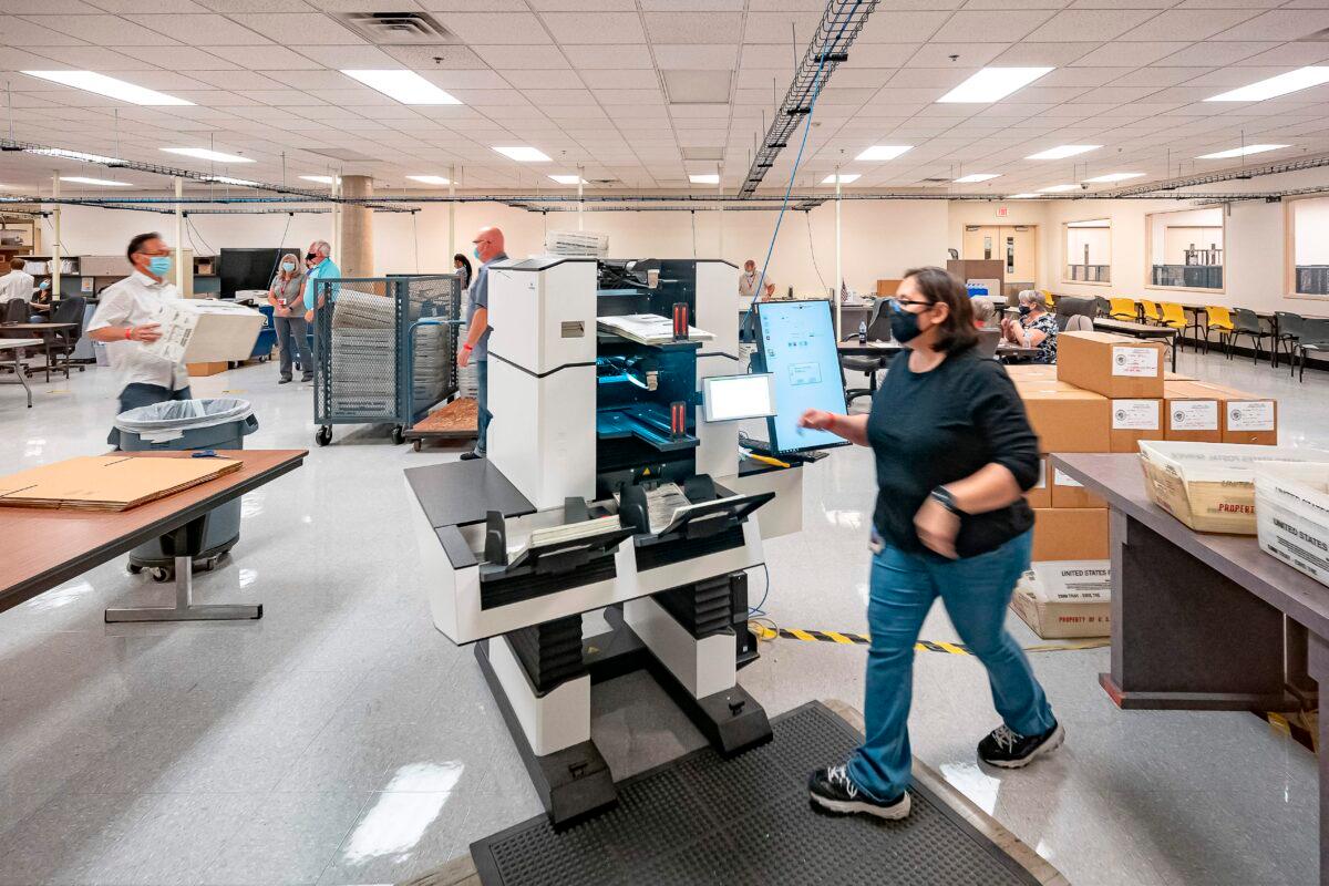 Poll workers count ballots inside the Maricopa County Election Department in Phoenix, on Nov. 5, 2020. (Olivier Touron/AFP via Getty Images)