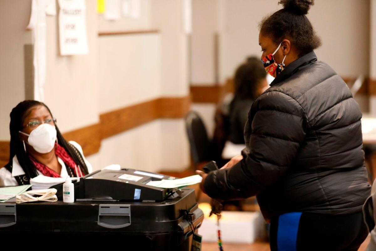 A voter puts their ballot in the tabulation machine after voting in the 2020 general election at the Northwest Activities Center in Detroit, Mich., on Nov. 3, 2020. (Jeff Kowalsky/AFP via Getty Images)