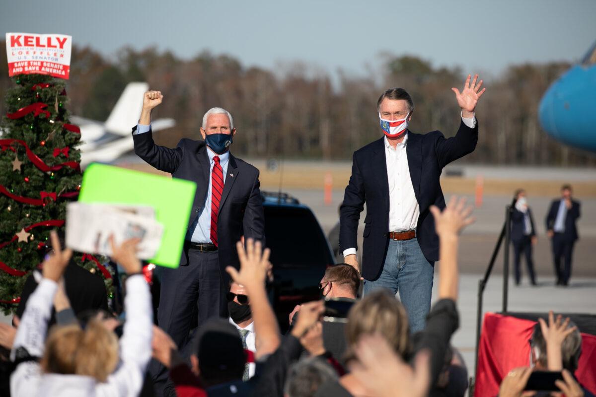 Vice President Mike Pence and Sen. David Purdue (R-Ga.) wave to the crowd during a rally in August, Ga., on Dec. 10, 2020. (Jessica McGowan/Getty Images)