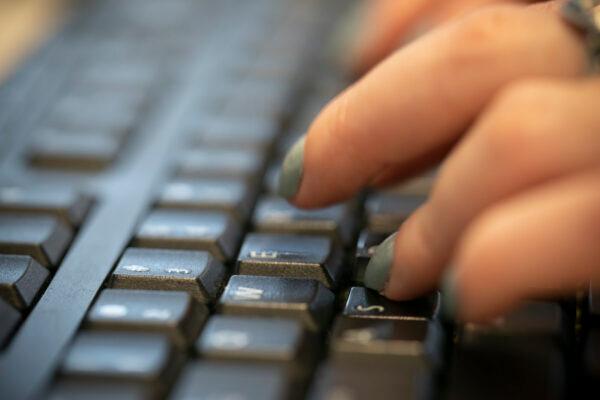 A woman types on a keyboard in New York, N.Y., in a file photograph. (Jenny Kane/AP Photo)