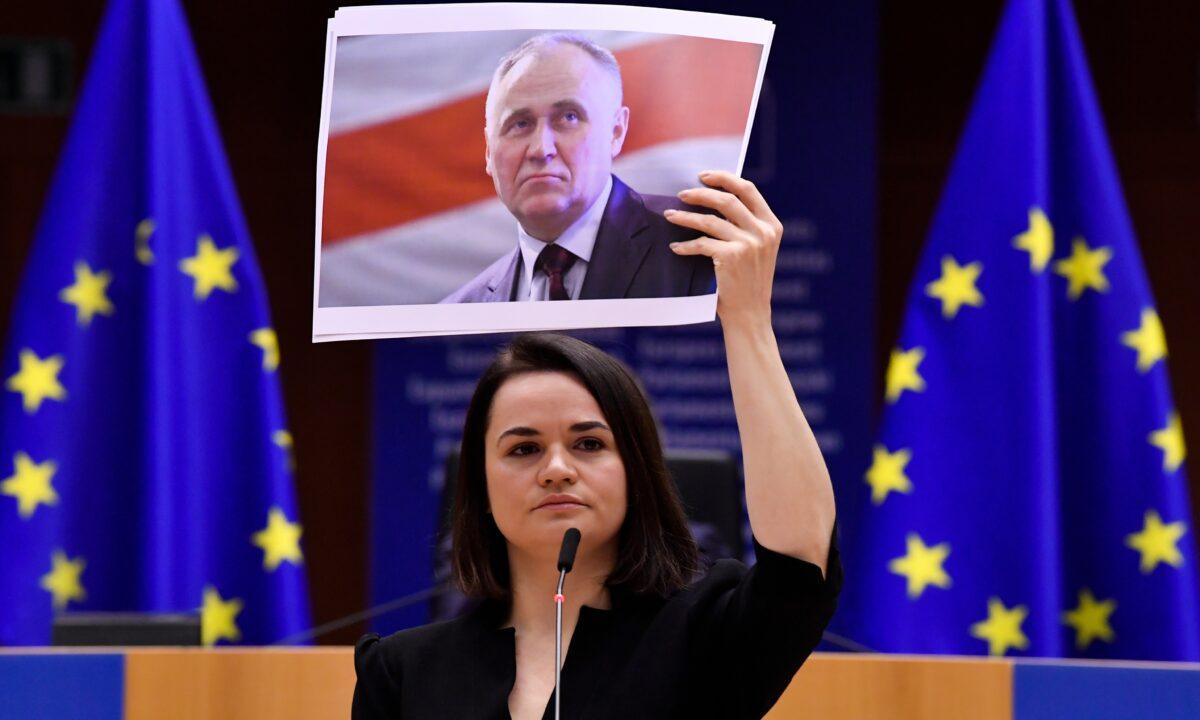 Belarusian opposition politician Sviatlana Tsikhanouskaya holds a picture of Belarusian politician Mikalai Statkevich as she gives a speech during the Sakharov Prize ceremony at the European Parliament in Brussels, on Dec. 16, 2020.  (John Thys/Pool via AP)